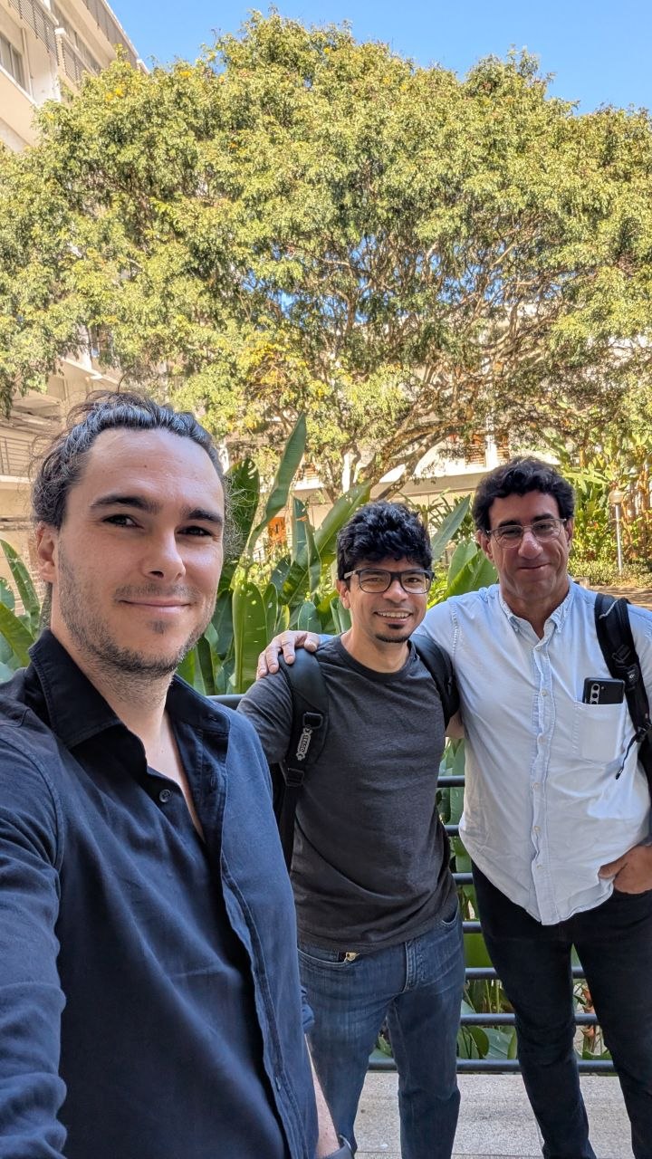 Three people standing outdoors on the UFMG campus